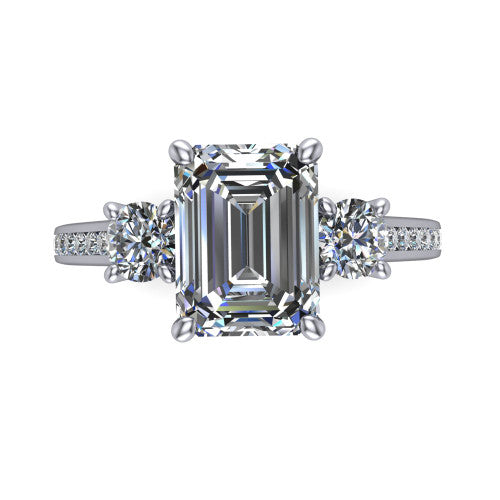 Saoirse emerald three stone engagement ring in Platinum, top-down view showing the center diamond flanked by two round side stones in a three stone setting