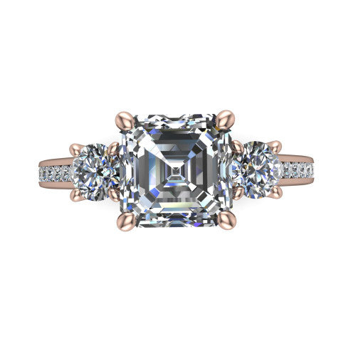Saoirse asscher three stone engagement ring in 14K Rose Gold, top-down view showing the center diamond flanked by two round side stones in a three stone setting