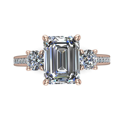 Saoirse emerald three stone engagement ring in 14K Rose Gold, top-down view showing the center diamond flanked by two round side stones in a three stone setting
