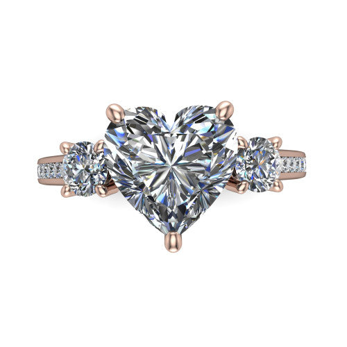 Saoirse heart three stone engagement ring in 18K Rose Gold, top-down view showing the center diamond flanked by two round side stones in a three stone setting