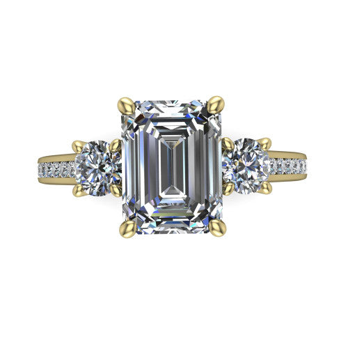 Saoirse emerald three stone engagement ring in 18K Yellow Gold, top-down view showing the center diamond flanked by two round side stones in a three stone setting