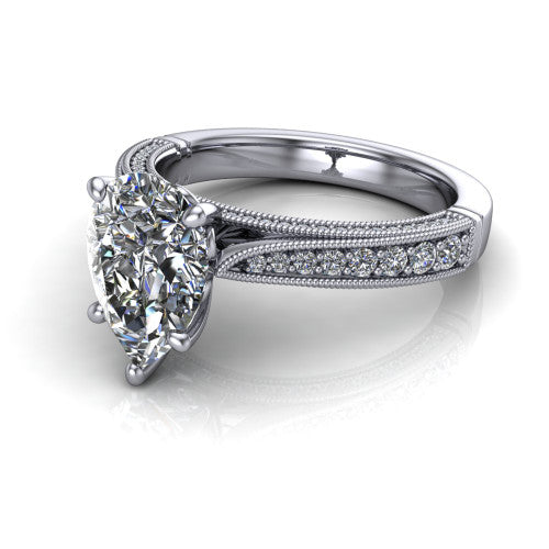 Maeve pear classic engagement ring in Platinum, three-quarter perspective showing the solitaire center diamond raised above a milgrain-edged pav&eacute; shank