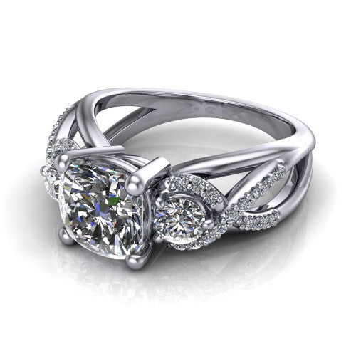 Amara cushion three stone engagement ring in Platinum, three-quarter perspective showing the center diamond between two round side stones above an infinity-twist pav&eacute; shank