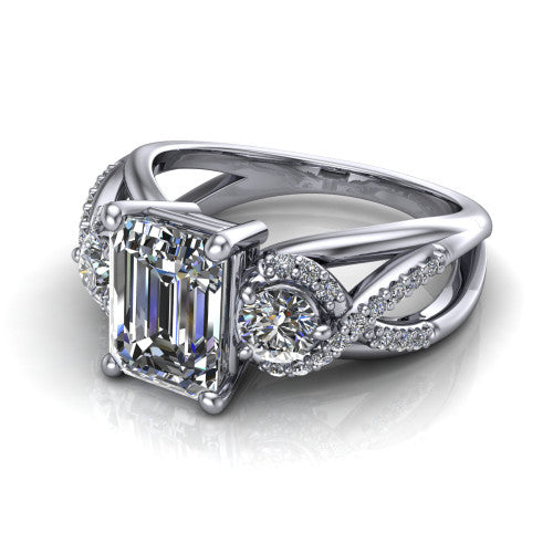 Amara emerald three stone engagement ring in Platinum, three-quarter perspective showing the center diamond between two round side stones above an infinity-twist pav&eacute; shank