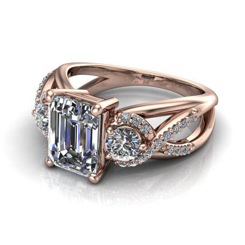 Amara emerald three stone engagement ring in 14K Rose Gold, three-quarter perspective showing the center diamond between two round side stones above an infinity-twist pav&eacute; shank