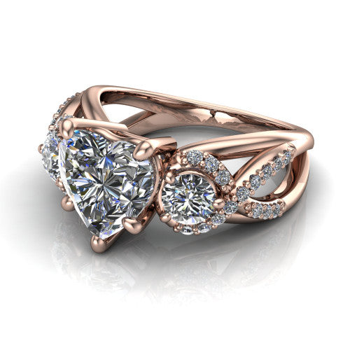 Amara heart three stone engagement ring in 14K Rose Gold, three-quarter perspective showing the center diamond between two round side stones above an infinity-twist pav&eacute; shank