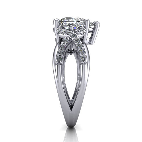 Amara pear three stone engagement ring in Platinum, side profile showing the pav&eacute; rails crossing in an infinity twist beneath the head