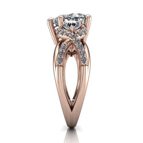 Amara heart three stone engagement ring in 18K Rose Gold, side profile showing the pav&eacute; rails crossing in an infinity twist beneath the head