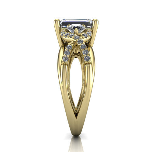 Amara emerald three stone engagement ring in 18K Yellow Gold, side profile showing the pav&eacute; rails crossing in an infinity twist beneath the head