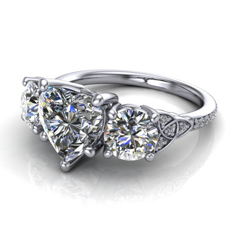 Zion heart three stone engagement ring in 18K White Gold, three-quarter perspective showing the center diamond between two round side stones with Celtic trinity-knot shoulders above a pav&eacute; shank