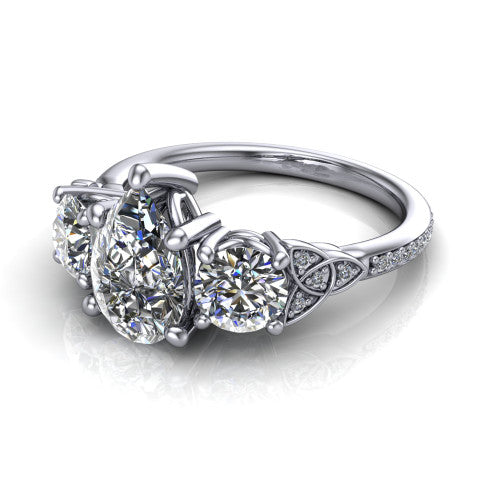 Zion pear three stone engagement ring in Platinum, three-quarter perspective showing the center diamond between two round side stones with Celtic trinity-knot shoulders above a pav&eacute; shank