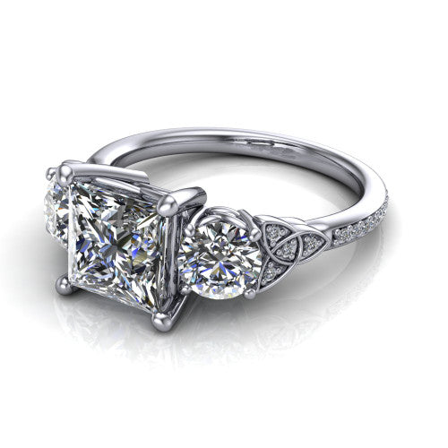 Zion princess three stone engagement ring in Platinum, three-quarter perspective showing the center diamond between two round side stones with Celtic trinity-knot shoulders above a pav&eacute; shank