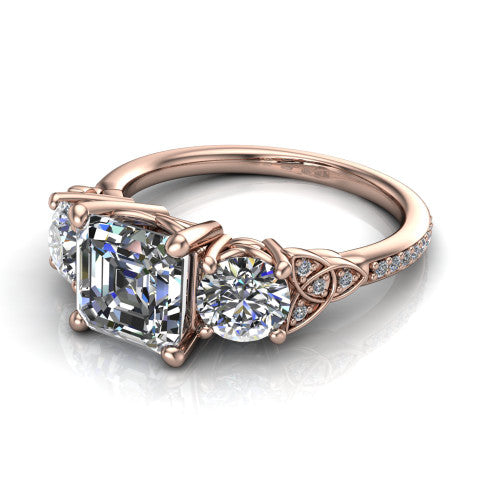 Zion asscher three stone engagement ring in 14K Rose Gold, three-quarter perspective showing the center diamond between two round side stones with Celtic trinity-knot shoulders above a pav&eacute; shank