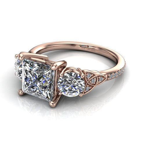 Zion princess three stone engagement ring in 18K Rose Gold, three-quarter perspective showing the center diamond between two round side stones with Celtic trinity-knot shoulders above a pav&eacute; shank