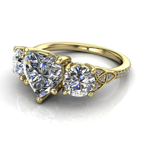 Zion heart three stone engagement ring in 14K Yellow Gold, three-quarter perspective showing the center diamond between two round side stones with Celtic trinity-knot shoulders above a pav&eacute; shank