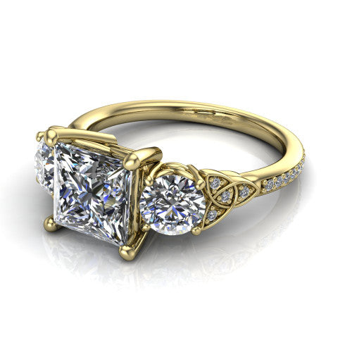 Zion princess three stone engagement ring in 18K Yellow Gold, three-quarter perspective showing the center diamond between two round side stones with Celtic trinity-knot shoulders above a pav&eacute; shank