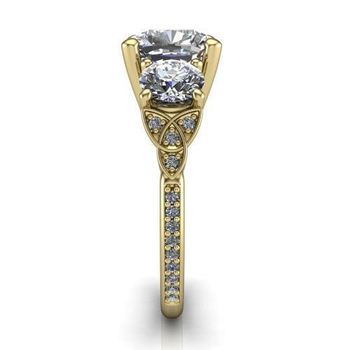 Zion cushion three stone engagement ring in 18K Yellow Gold, side profile showing the trinity-knot shoulder and the pav&eacute; diamonds running down the shank