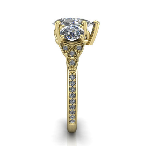 Zion pear three stone engagement ring in 14K Yellow Gold, side profile showing the trinity-knot shoulder and the pav&eacute; diamonds running down the shank