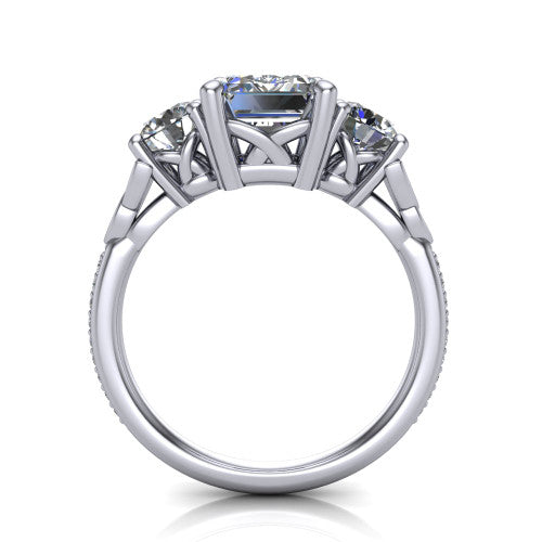 Zion emerald three stone engagement ring in Platinum, through-finger front profile showing the three-stone head raised above the Celtic knot shoulders and pav&eacute; band