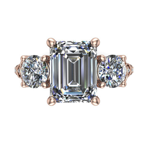 Zion emerald three stone engagement ring in 14K Rose Gold, top-down view showing the center diamond flanked by two round side stones and trinity-knot shoulder detailing