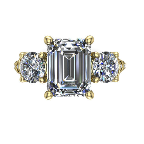 Zion emerald three stone engagement ring in 14K Yellow Gold, top-down view showing the center diamond flanked by two round side stones and trinity-knot shoulder detailing