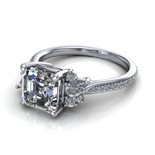 Mila asscher three stone engagement ring in 18K White Gold, three-quarter perspective showing the center diamond flanked by round accent clusters above a pav&eacute; shank