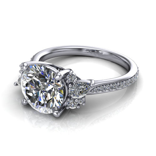 Mila round three stone engagement ring in Platinum, three-quarter perspective showing the center diamond flanked by round accent clusters above a pav&eacute; shank
