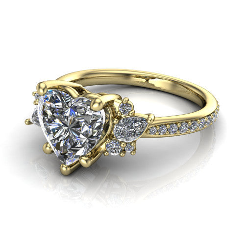 Mila heart three stone engagement ring in 18K Yellow Gold, three-quarter perspective showing the center diamond flanked by round accent clusters above a pav&eacute; shank