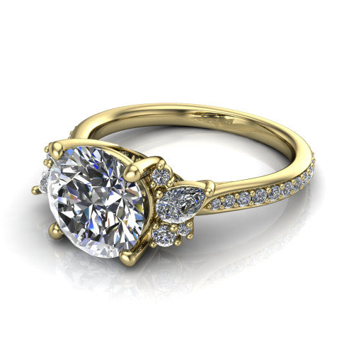 Mila round three stone engagement ring in 18K Yellow Gold, three-quarter perspective showing the center diamond flanked by round accent clusters above a pav&eacute; shank