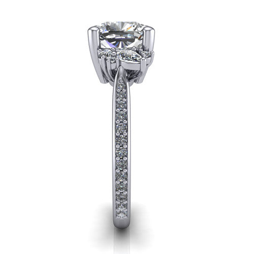 Mila cushion three stone engagement ring in Platinum, side profile showing the round accent cluster and the pav&eacute; diamonds running down the shank