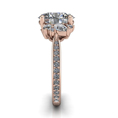 Mila oval three stone engagement ring in 18K Rose Gold, side profile showing the round accent cluster and the pav&eacute; diamonds running down the shank