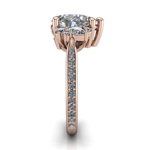 Mila pear three stone engagement ring in 18K Rose Gold, side profile showing the round accent cluster and the pav&eacute; diamonds running down the shank