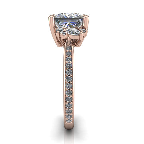 Mila princess three stone engagement ring in 18K Rose Gold, side profile showing the round accent cluster and the pav&eacute; diamonds running down the shank