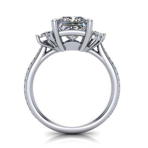 Mila princess three stone engagement ring in Platinum, through-finger front profile showing the center head raised above the round accent clusters and pav&eacute; band