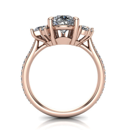 Mila pear three stone engagement ring in 18K Rose Gold, through-finger front profile showing the center head raised above the round accent clusters and pav&eacute; band