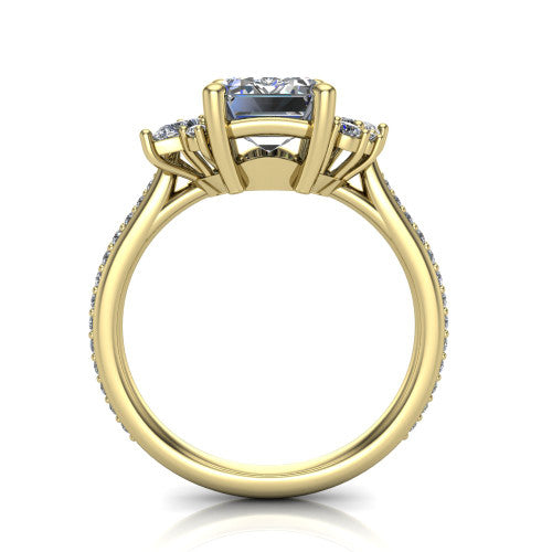 Mila emerald three stone engagement ring in 14K Yellow Gold, through-finger front profile showing the center head raised above the round accent clusters and pav&eacute; band