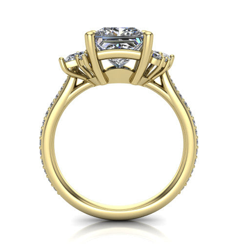 Mila princess three stone engagement ring in 14K Yellow Gold, through-finger front profile showing the center head raised above the round accent clusters and pav&eacute; band