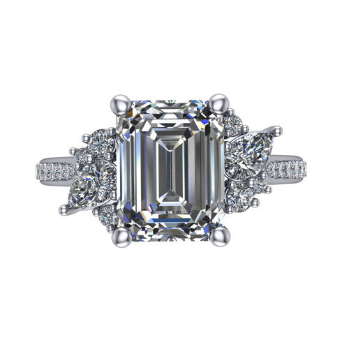 Mila emerald three stone engagement ring in 18K White Gold, top-down view showing the center diamond between two trios of round accent diamonds