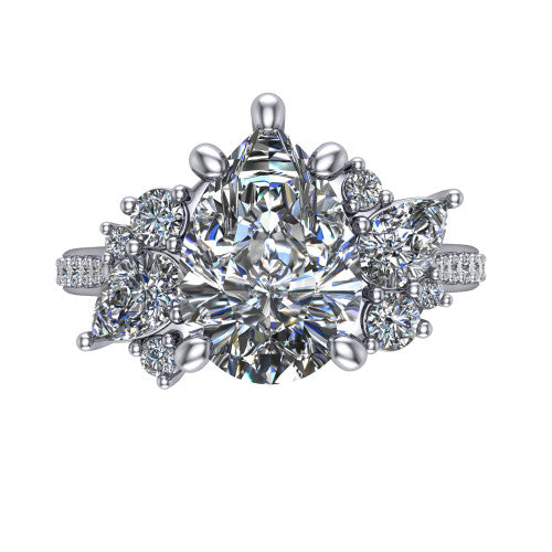 Mila pear three stone engagement ring in Platinum, top-down view showing the center diamond between two trios of round accent diamonds