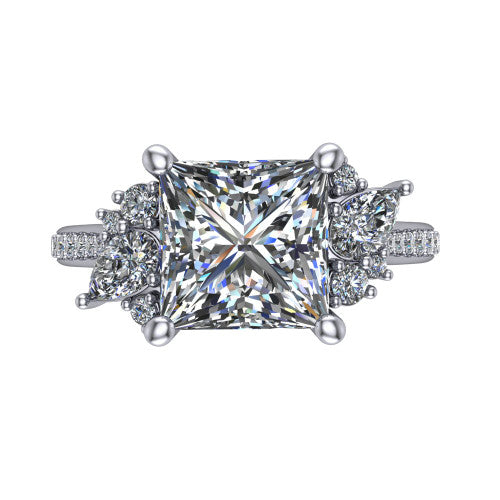 Mila princess three stone engagement ring in 18K White Gold, top-down view showing the center diamond between two trios of round accent diamonds