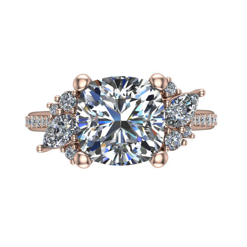 Mila cushion three stone engagement ring in 14K Rose Gold, top-down view showing the center diamond between two trios of round accent diamonds