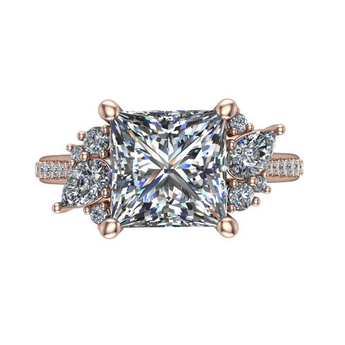 Mila princess three stone engagement ring in 18K Rose Gold, top-down view showing the center diamond between two trios of round accent diamonds
