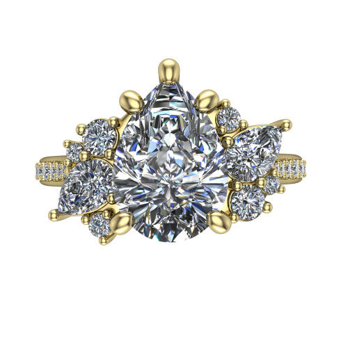 Mila pear three stone engagement ring in 14K Yellow Gold, top-down view showing the center diamond between two trios of round accent diamonds