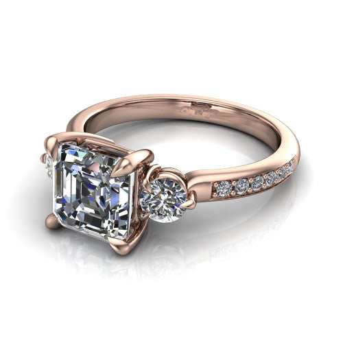 Blake asscher three stone engagement ring in 14K Rose Gold, three-quarter perspective showing the center diamond between two round side stones above a pav&eacute; shank