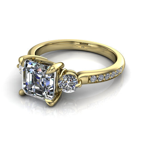 Blake asscher three stone engagement ring in 18K Yellow Gold, three-quarter perspective showing the center diamond between two round side stones above a pav&eacute; shank