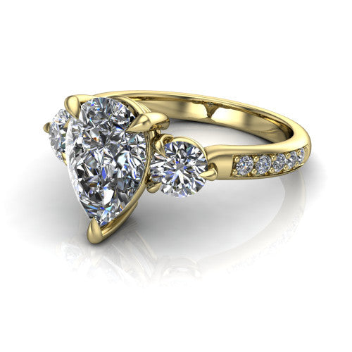 Blake pear three stone engagement ring in 14K Yellow Gold, three-quarter perspective showing the center diamond between two round side stones above a pav&eacute; shank