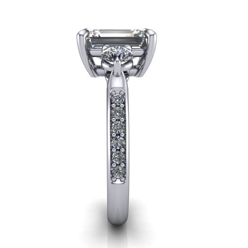 Blake emerald three stone engagement ring in 18K White Gold, side profile showing the round side stone and the pav&eacute; diamonds running down the shank