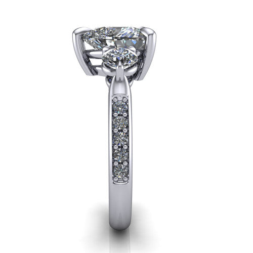 Blake heart three stone engagement ring in Platinum, side profile showing the round side stone and the pav&eacute; diamonds running down the shank