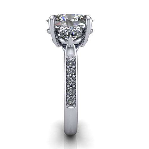 Blake oval three stone engagement ring in Platinum, side profile showing the round side stone and the pav&eacute; diamonds running down the shank