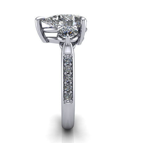 Blake pear three stone engagement ring in 14K White Gold, side profile showing the round side stone and the pav&eacute; diamonds running down the shank